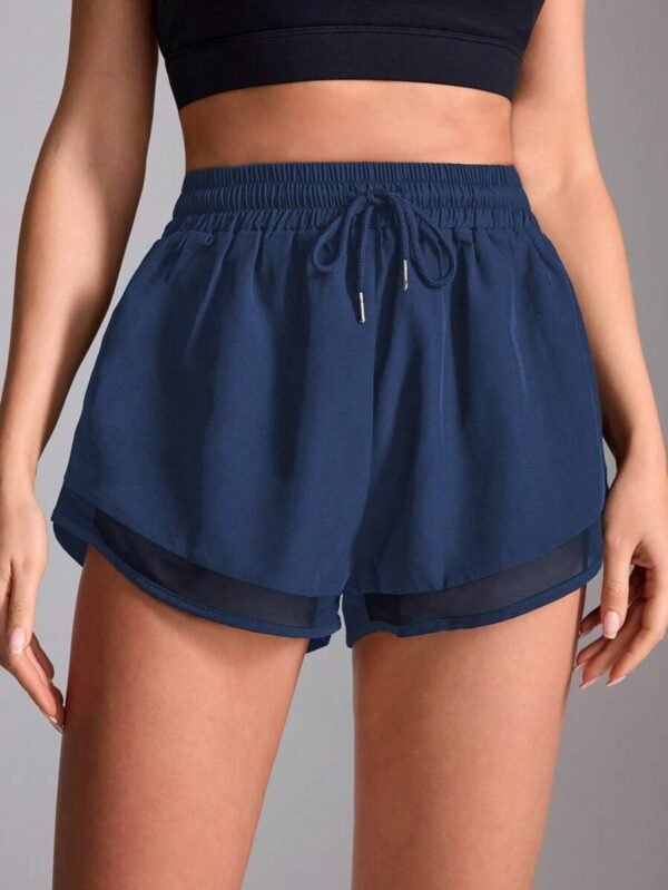 Pantalones cortos deportivos para mujer con contraste de malla
