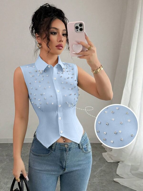 Blusa elegante sin mangas con talle ceñido y con perlas